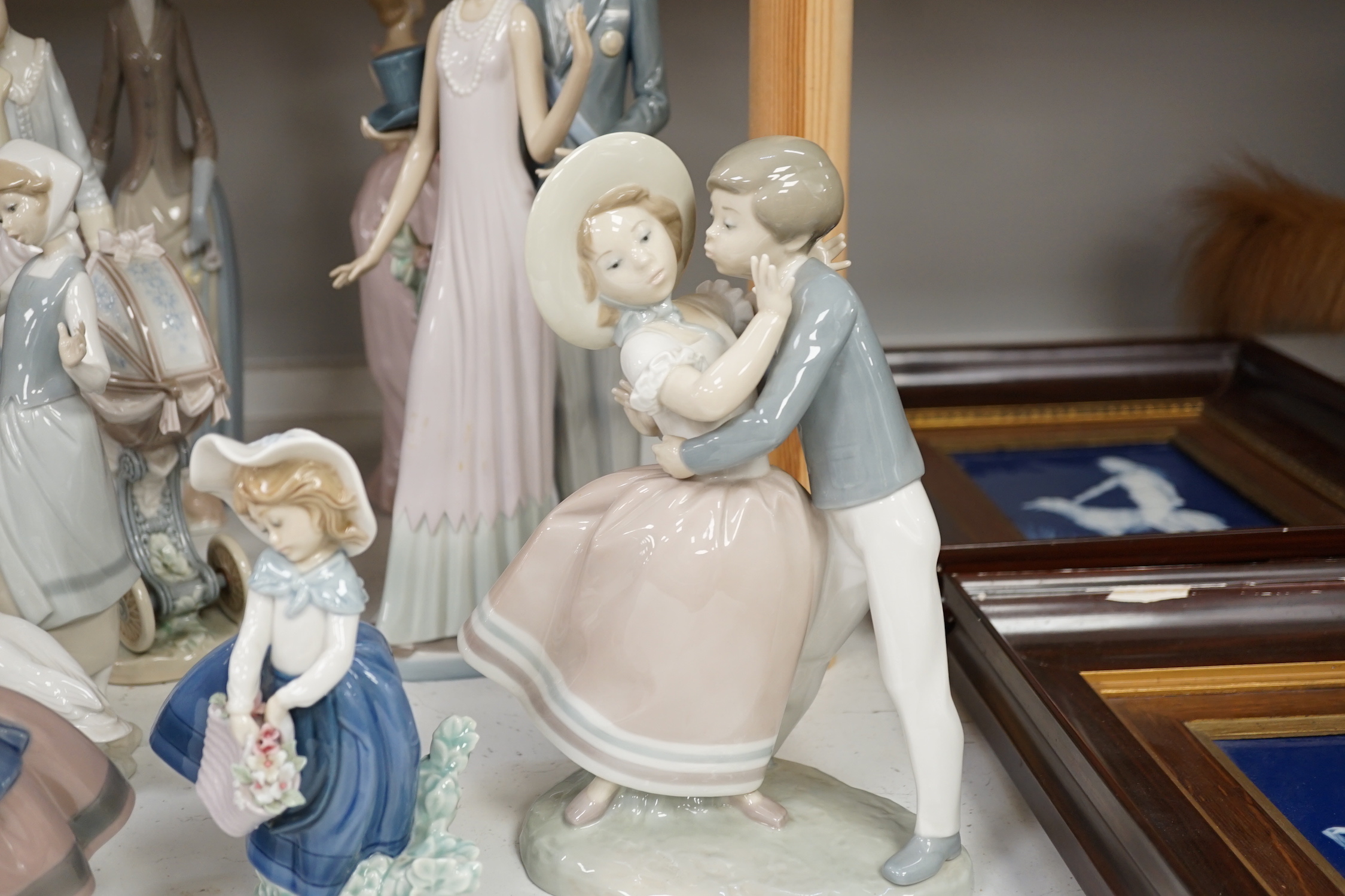 Collection of twelve Lladro figures including Precious Love and High Society